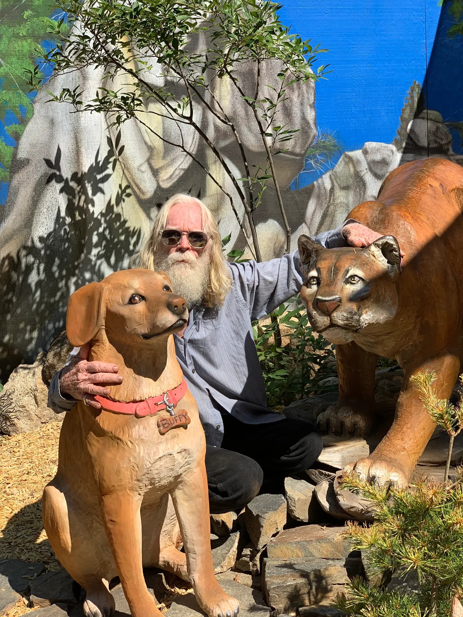 David Roy with one of his chainsaw carvings